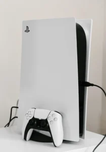 standing PlayStation 5 with controller